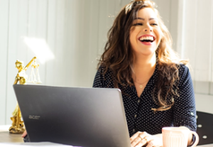 Female at her computer laughihng