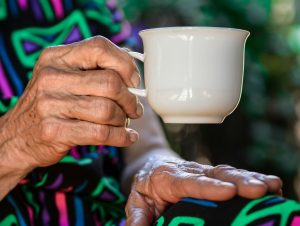 old person having a cup of tea care home sponsor licence
