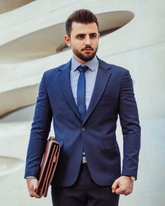 self-sponsorship visa man in blue suit with briefcase